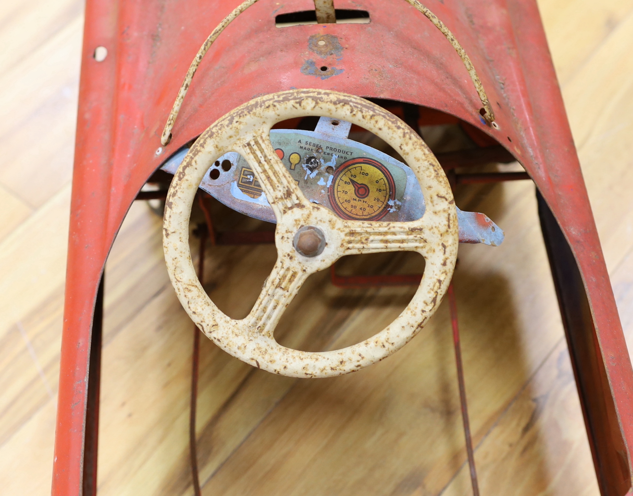 A Sebel tinplate pedal car circa 1960, 90cm long (a.f.)